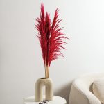 Stems of deep pink preserved Pampas grass in a contemporary vase.